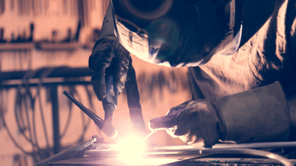 Worker welding with mig/tig welding machine