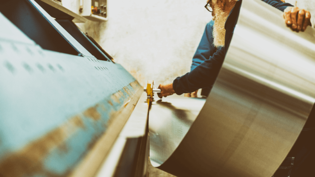 Worker is bending sheet metal