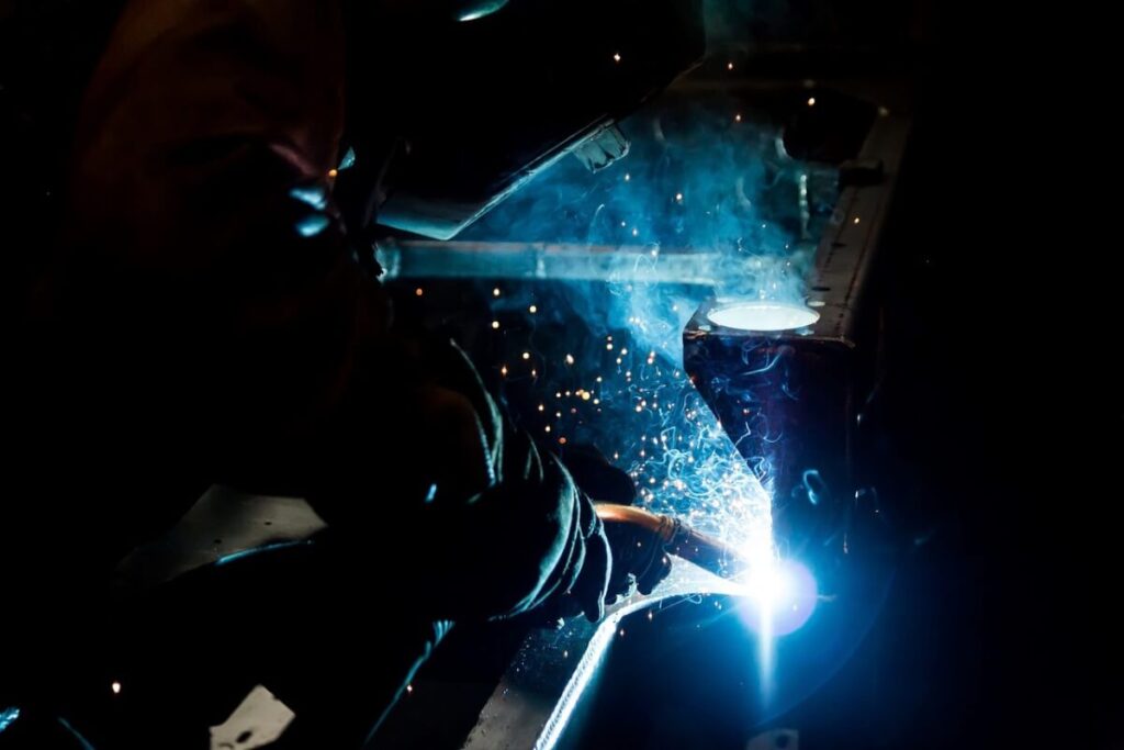 Women is welding with welding machine