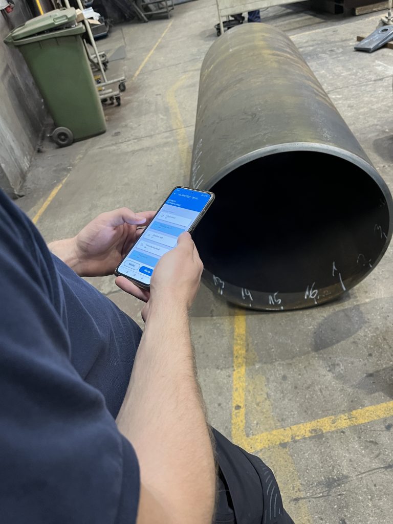 EZIIL mobile reporting app used in a steel fabrication shop